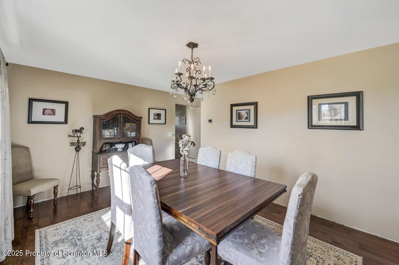 2225 Cherry Hill Road Clarks Summit, PA 18411 - Photo 21 of 81 a view of a dining room with furniture a chandelier and wooden floor