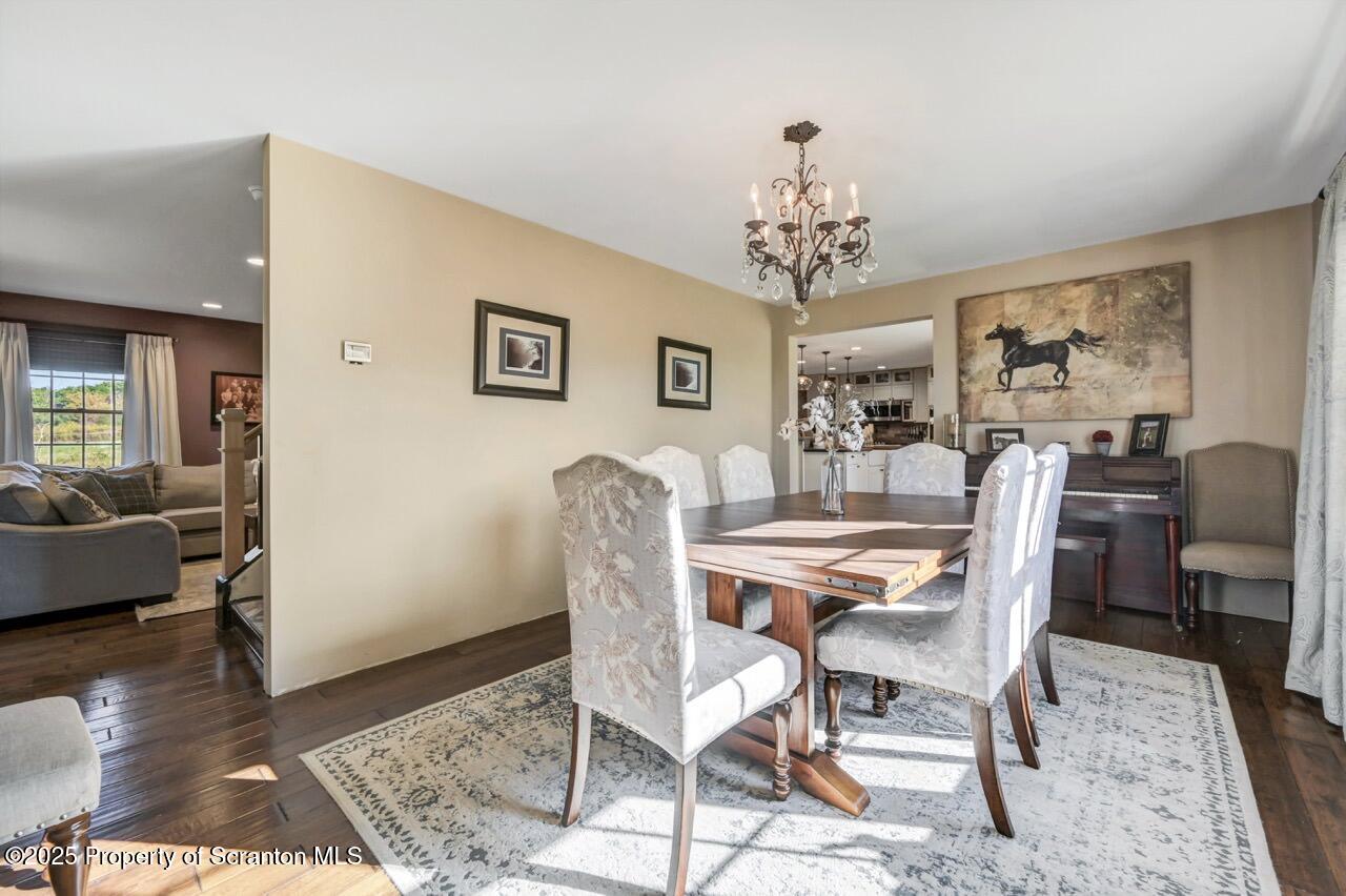 2225 Cherry Hill Road Clarks Summit, PA 18411 - Photo 22 of 81 a dining room with furniture a chandelier and wooden floor