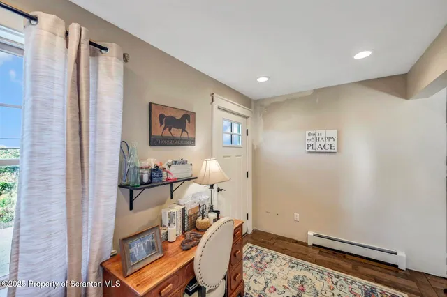a view of a workspace with furniture and a window