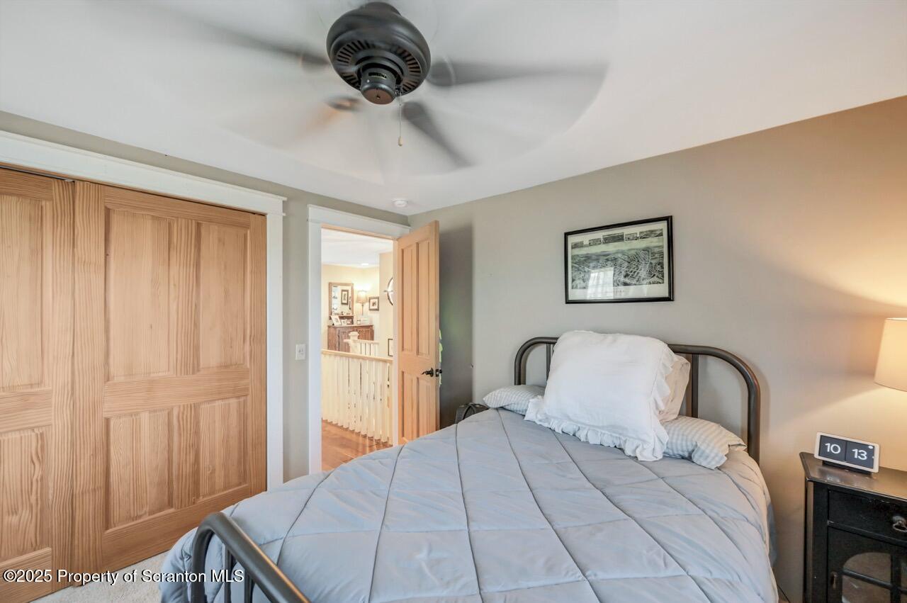 2225 Cherry Hill Road Clarks Summit, PA 18411 - Photo 48 of 81 a bedroom with a large bed and a chandelier