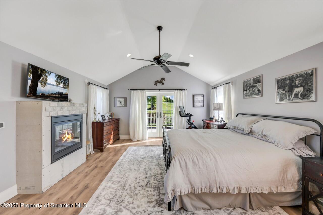 2225 Cherry Hill Road Clarks Summit, PA 18411 - Photo 49 of 81 a spacious bedroom with a bed and a fireplace