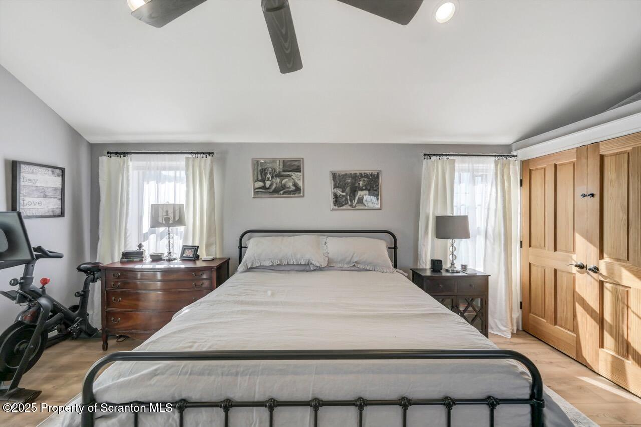 2225 Cherry Hill Road Clarks Summit, PA 18411 - Photo 53 of 81 a bedroom with a large bed and a chandelier