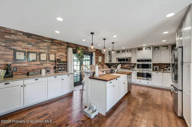 a kitchen with stainless steel appliances granite countertop a stove and cabinets