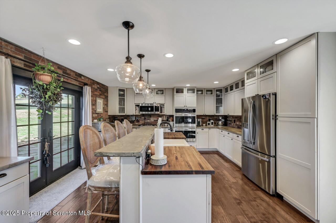 2225 Cherry Hill Road Clarks Summit, PA 18411 - Photo 9 of 81 a kitchen with refrigerator and chairs