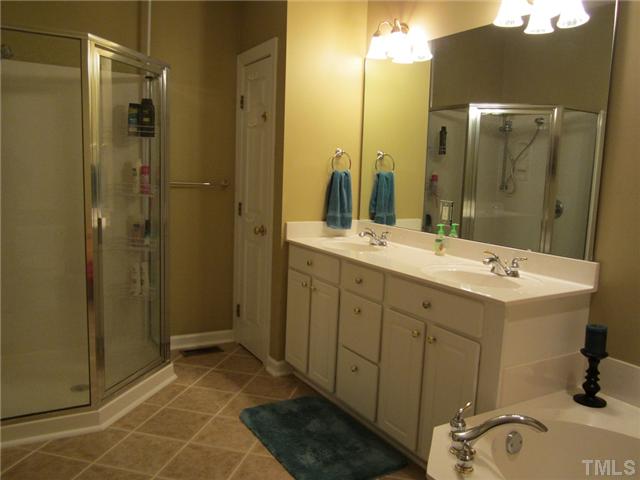 6405 Nowell Pointe Drive Raleigh, NC 27607 - Photo 12 of 19 Owners suite bath with seperate shower and garden tub, and tile floors.
