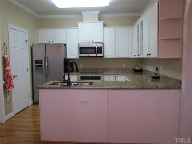 6405 Nowell Pointe Drive Raleigh, NC 27607 - Photo 6 of 19 Spacious kitchen with new appliances, granite and hardwood flooring.