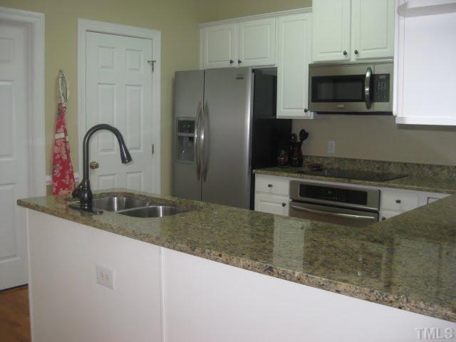 6405 Nowell Pointe Drive Raleigh, NC 27607 - Photo 7 of 19 LOADS OF COUNTER SPACE AND PANTRY. LAUNDRY ROOM OFF THE KITCHEN.