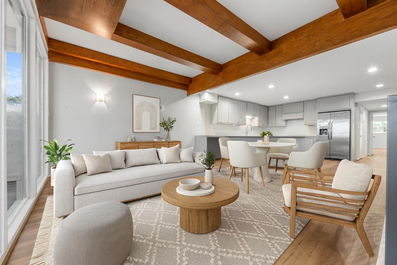 a living room with furniture and a dining table with kitchen view