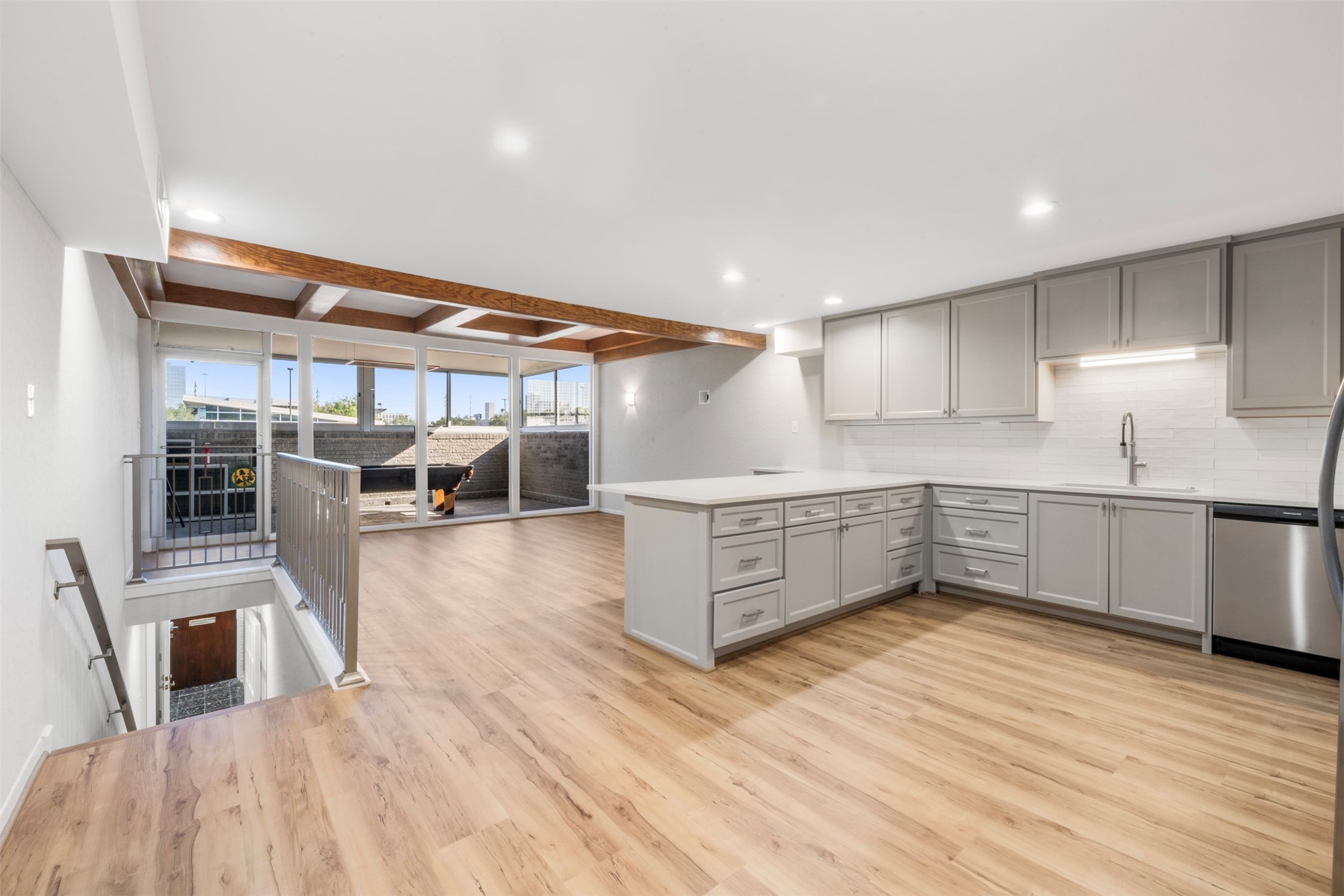 3141 Bissonnet Street Houston, TX 77005 - Photo 26 of 45 a kitchen with stainless steel appliances refrigerator wooden floor dining table and chairs