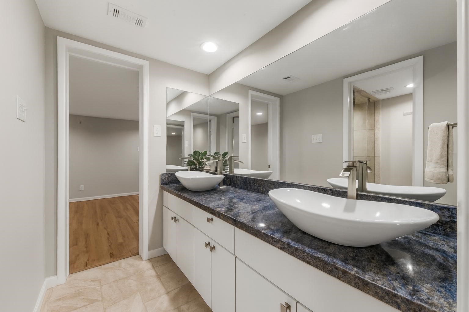 3141 Bissonnet Street Houston, TX 77005 - Photo 10 of 45 a spacious bathroom with a double vanity sink and a mirror