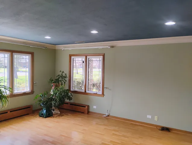 an empty room with mirror and windows