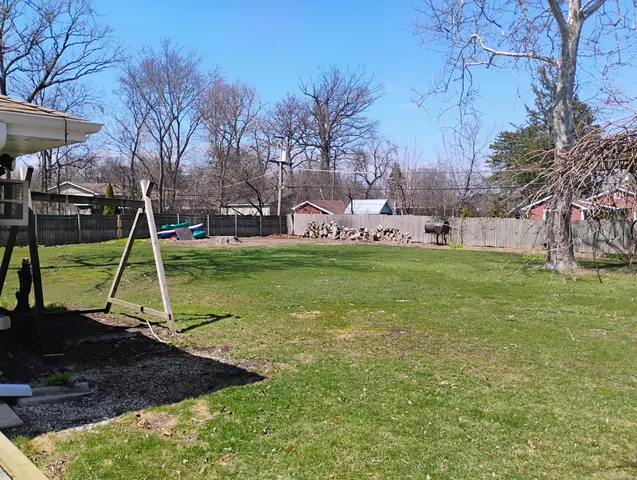 a view of a backyard with large trees