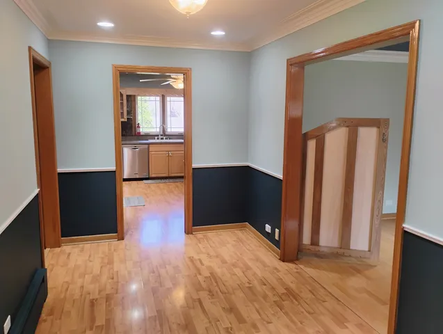 a view of a kitchen with wooden floor and cabinets