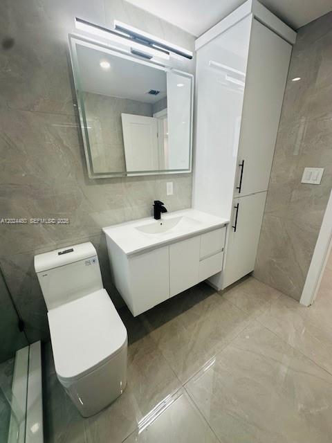 11870 Southwest 5th Street, Unit A Miami, FL 33184 - Photo 10 of 18 a bathroom with a sink and a mirror