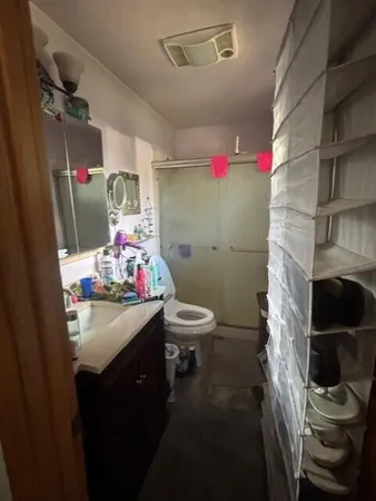 a bathroom with a sink toilet and shower