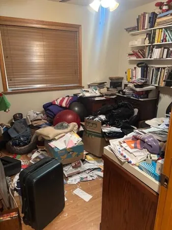 a bedroom with a bed and a book shelf