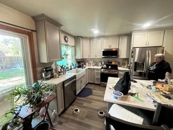 a kitchen with sink refrigerator and microwave