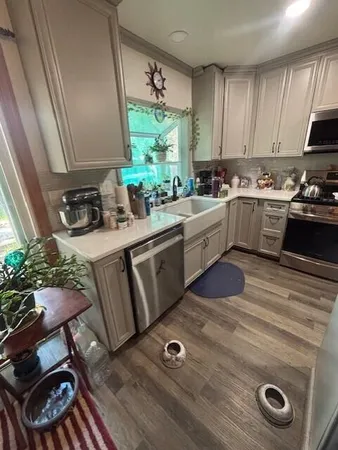a kitchen with a sink appliances and cabinets