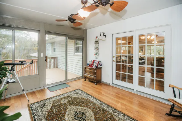 a living room with furniture and a floor to ceiling window