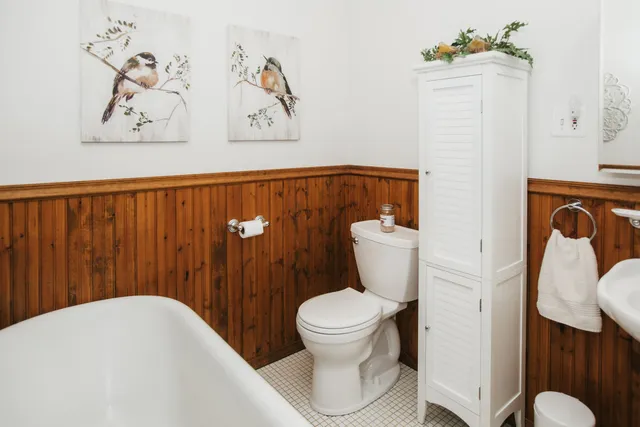 a white toilet sitting next to a bathroom sink