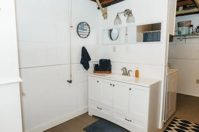 a kitchen with white cabinets and white appliances