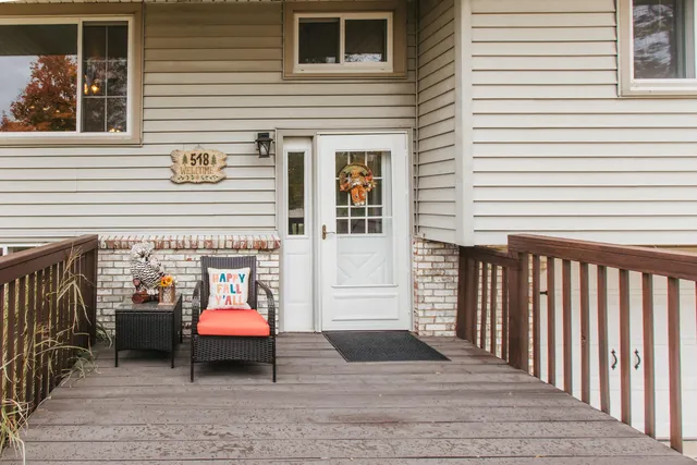 a view of a patio with a table and chairs and wooden floor