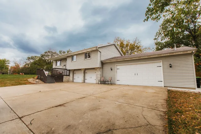 a view of a house with a backyard and garage