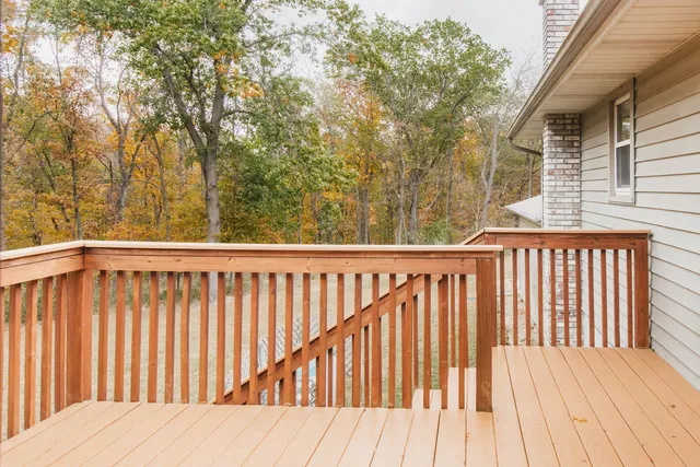 a balcony with wooden floor and fence