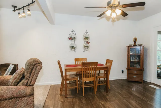 a view of a dining room with furniture and wooden floor