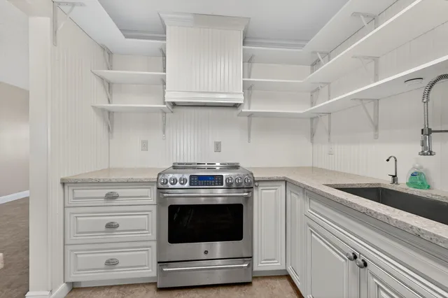 a kitchen with stainless steel appliances granite countertop a sink and cabinets