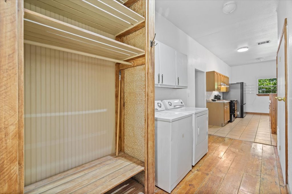 555 Harmon Hills Road, Unit A Dripping Springs, TX 78620 - Photo 20 of 29 Ample shelving and hanging space complement the convenient laundry area, ready for easy chores.