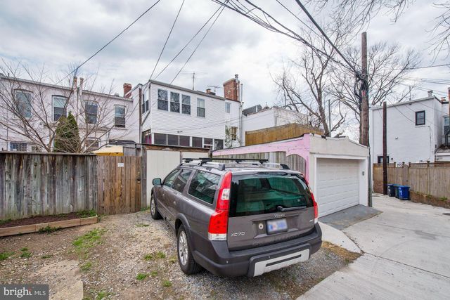 a view of a patio with chairs and table under an umbrella