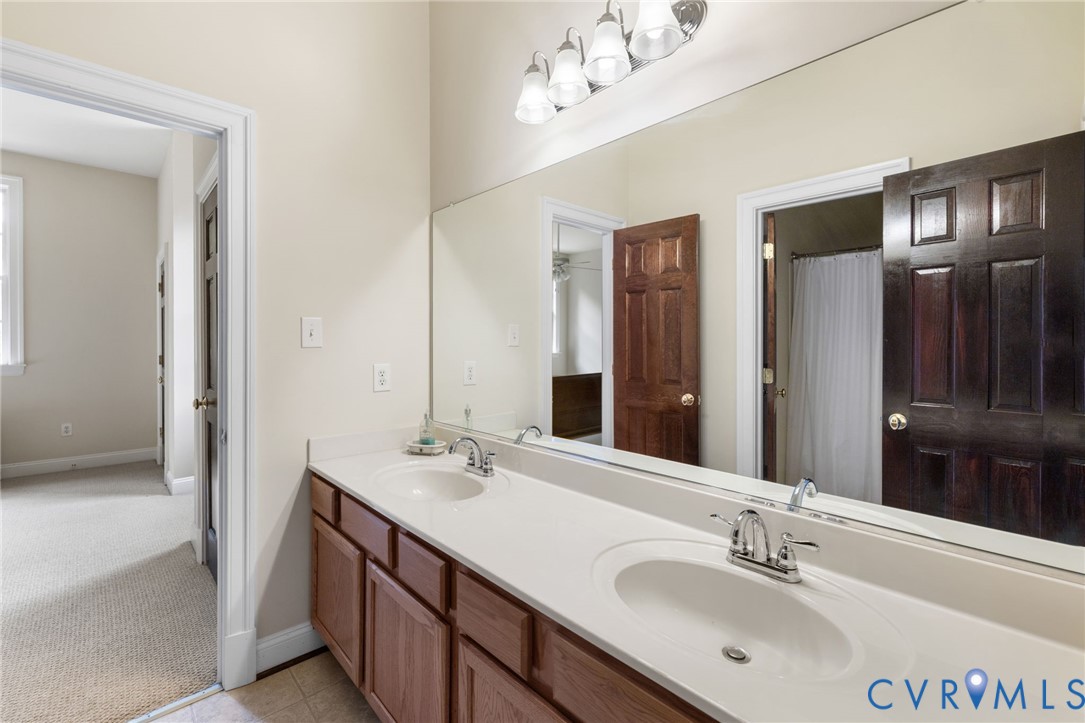 13173 Scotchtown Road Beaverdam, VA 23015 - Photo 49 of 65 a bathroom with a sink double vanity granite and a mirror