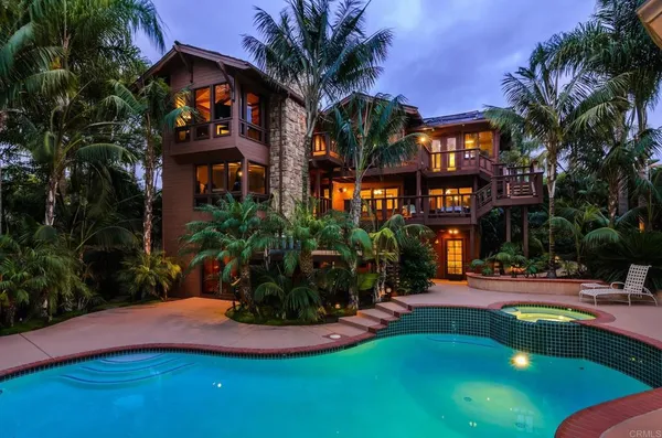 a view of a swimming pool with a house in the background