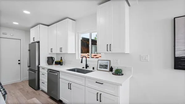 a kitchen with a sink cabinets and stainless steel appliances