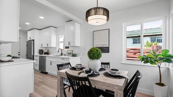 a very nice looking dining room with furniture a livingroom and chandelier