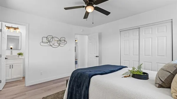 a bedroom with a bed and a chandelier