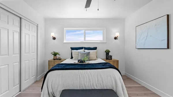 a bedroom with a bed and paintings on the wall