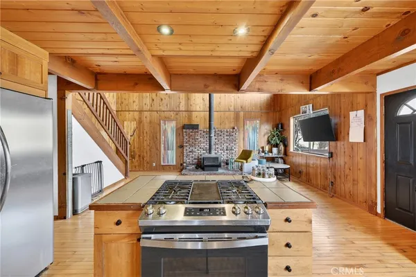 a kitchen with stainless steel appliances granite countertop a stove and a wooden floors