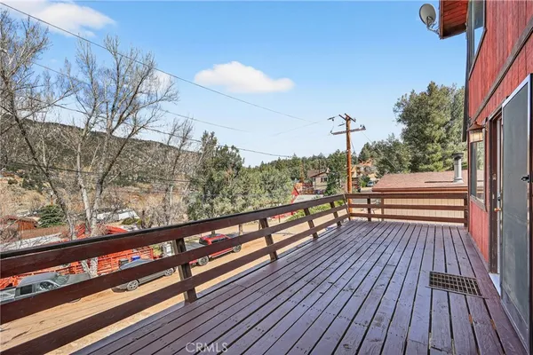 a view of a roof deck with wooden floor and fence
