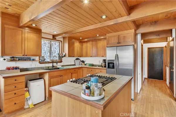 a kitchen with stainless steel appliances granite countertop a sink and a stove