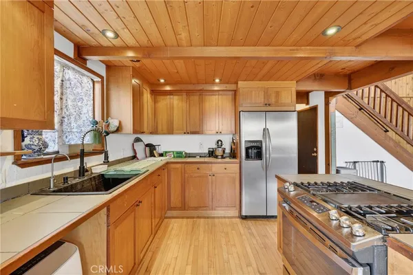 a kitchen with stainless steel appliances granite countertop a sink a stove and cabinets