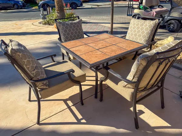 a view of a balcony with chairs and wooden floor
