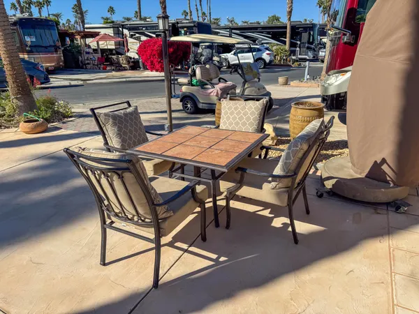a view of a swimming pool with outdoor seating and plants