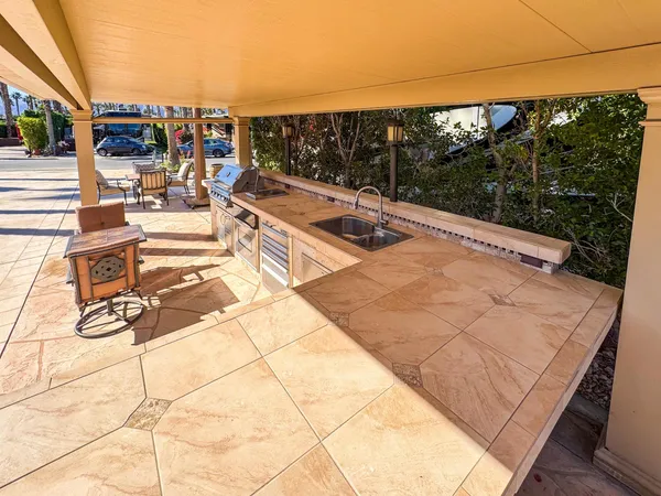 a view of swimming pool with seating area and barbeque oven