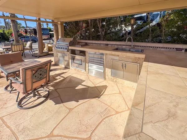 a view of backyard with swimming pool and furniture