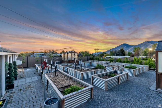 1720 Hillcrest Circle Mapleton, UT 84664 - Photo 14 of 116 Patio terrace at dusk with a fenced backyard, a patio, a mountain view, and a vegetable garden