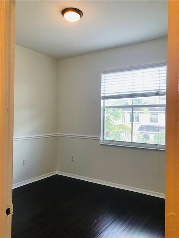 3533 Merrick Lane Margate, FL 33063 - Photo 11 of 14 an empty room with wooden floor and windows