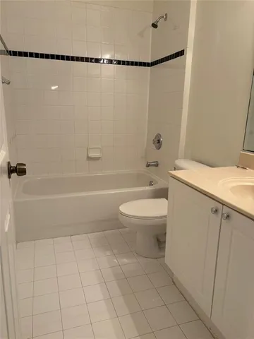 a bathroom with a shower a toilet and a sink