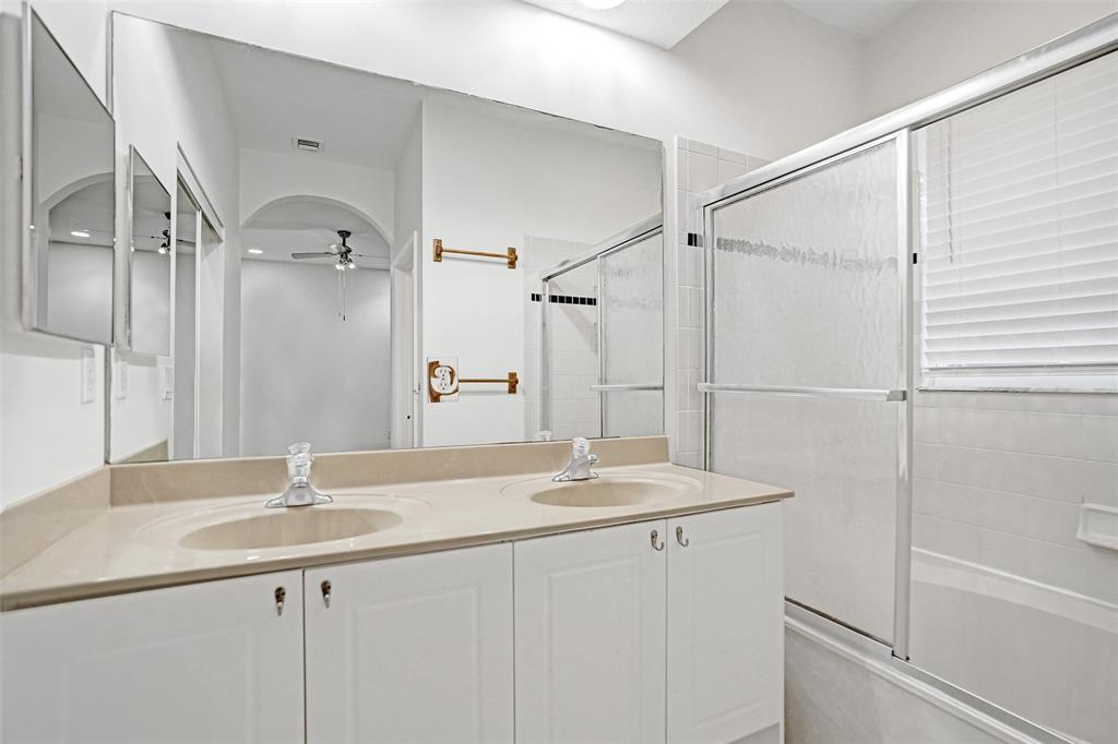 3533 Merrick Lane Margate, FL 33063 - Photo 20 of 27 a bathroom with a sink double vanity and a mirror